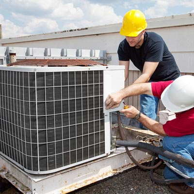 Workers repairing ac unit