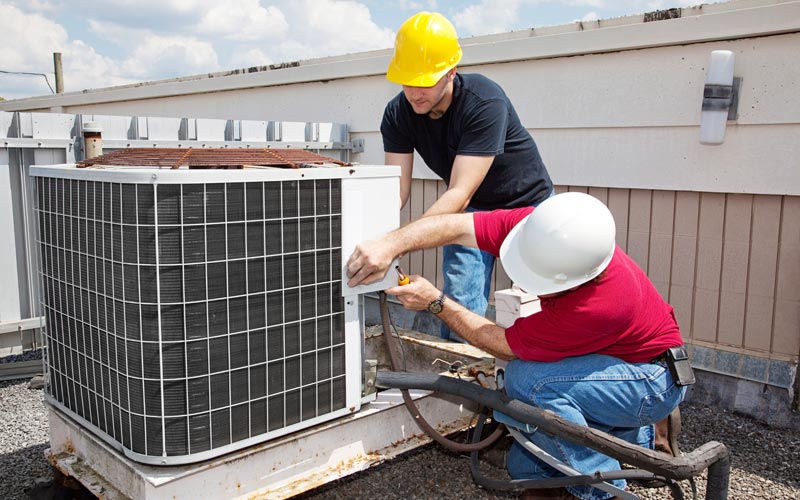 Workers repairing ac unit