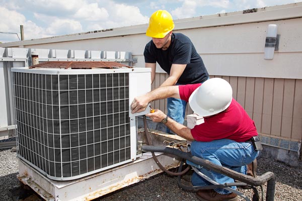 Workers repairing ac unit